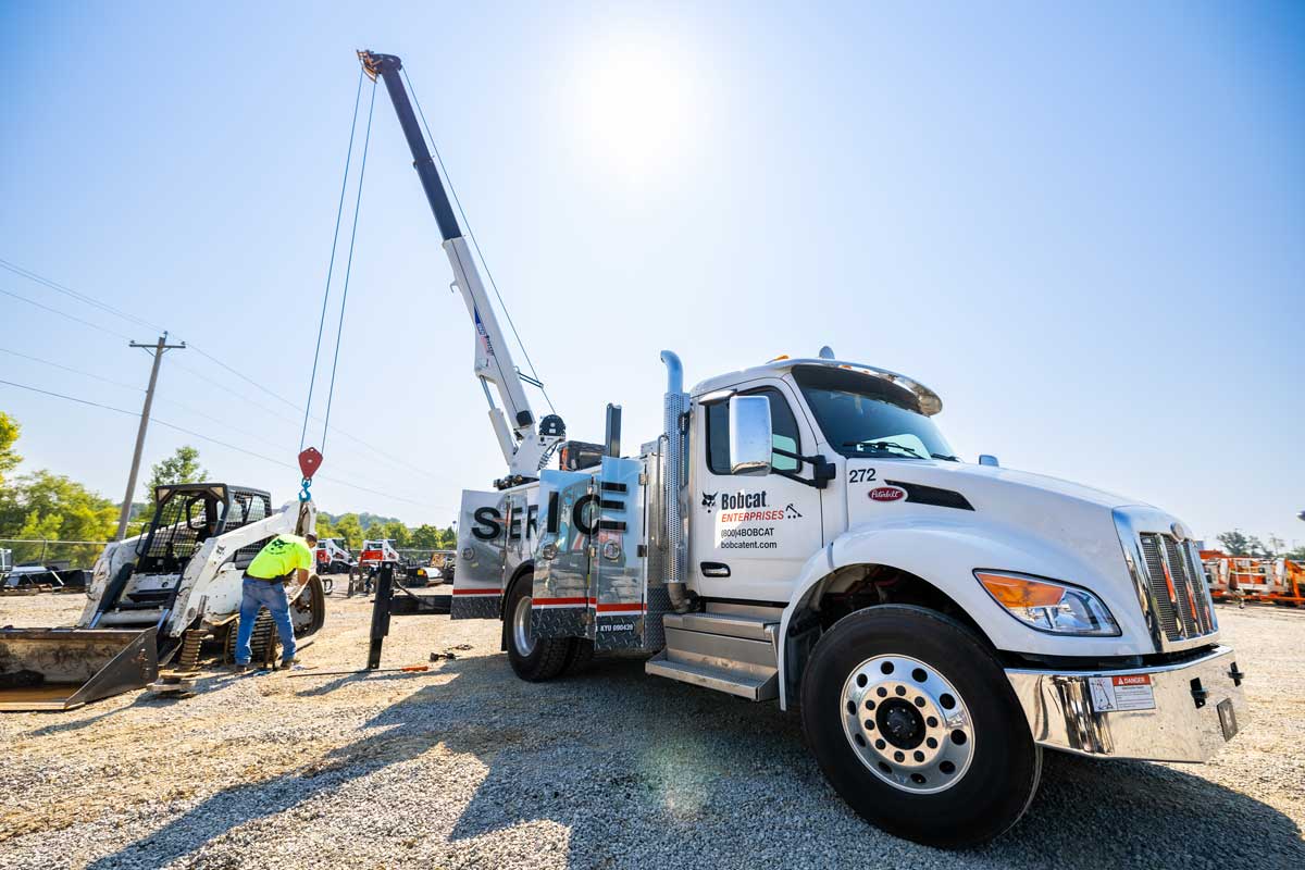 service truck working on Bobcat